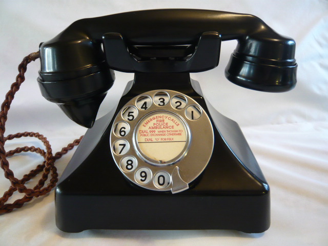 Old Bakelite dial up phone with emergency number 999 on the label